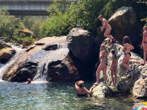 group of girls excitedly planning to jump into the water at Bridge Bay.